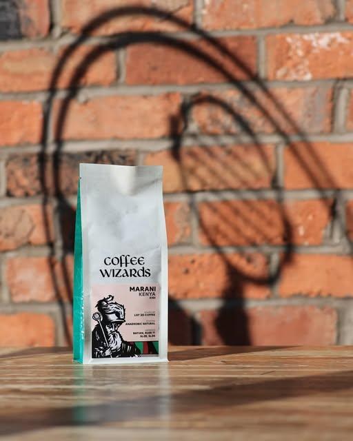 A branded Under Pressure Coffee retail bean bag against a brick wall